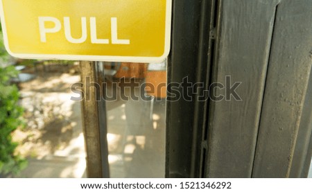 Yellow signboard with the word pull