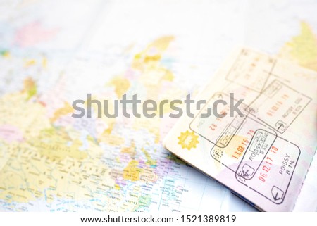 Passport on a map of the world. Globe map on a background.Departure and Arrival stamp with Visa on the page of Passport.Traveling Journey Vacation Holiday concept.