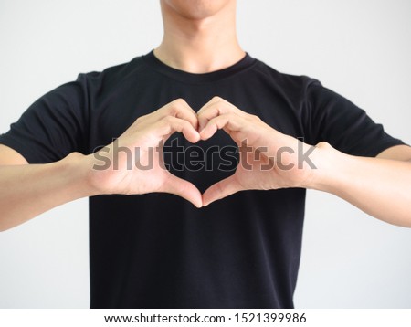 Portrait man black shirt make heart by hands crop body on white isolated background
