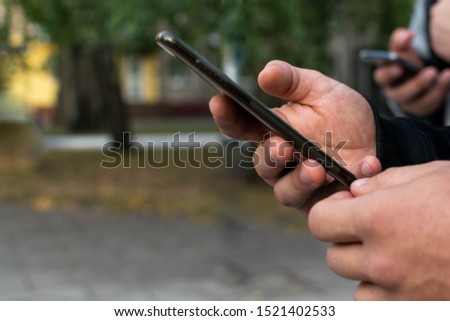 only human hands in which a black smartphone