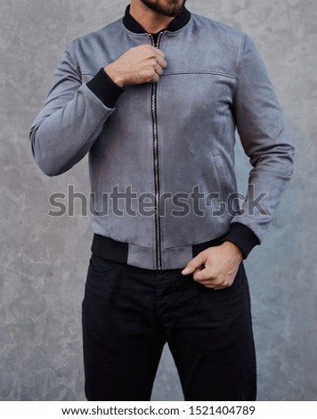man wears a grey suede jacket 