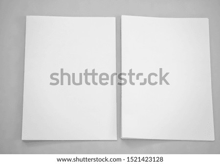 Top view of blank paper isolated on gray background. Poster mock-ups paper, white paper portrait A4. brochure magazine isolated, use banners products business cards to showcase your