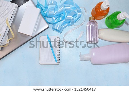 Sale, black friday, computer for orders in online stores, a set of creams for skin care and gift bags on a pink background, flat lay, top view. Concept of shopping and modern woman, place for text