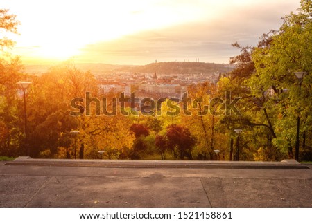 Sunset view of Prague from Vitkov hill with autumn park, scenic sunny cytiscape, Zizkov district, Czech Republic, travel background
