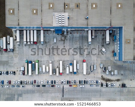 
4k Aerial shot of trucks on warehouse parking terminal.