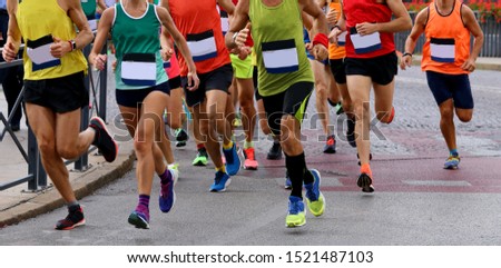 group of athletes runninng on the road during a footrace Royalty-Free Stock Photo #1521487103