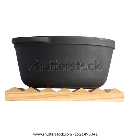 empty black iron cast cauldron on a cutting board, cast iron black pot, kettle cookware, isolated on perfect white background, stock photography  