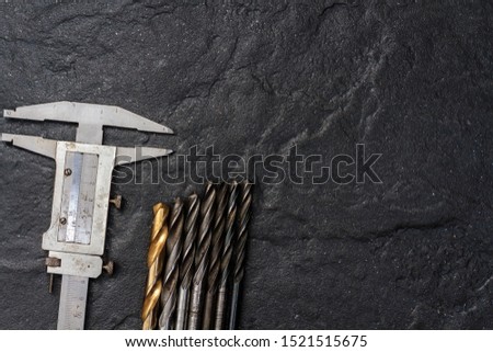 Measuring tool. Vernier caliper on black stone. Background, texture. Close-up