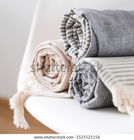 peshtemal Turkish towels folded on white chair cotton national textile Royalty-Free Stock Photo #1521521156