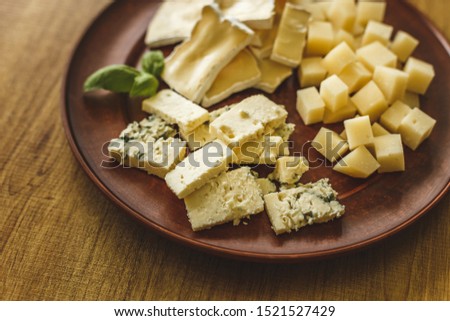 Various types of cheese on a gray background. Top view