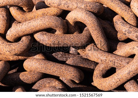 Detail of giant rusty metal chain used in shipping industry. Background with rough texture. Nautical industry.