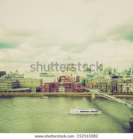 Vintage looking Wide angle view of Saint Paul's Cathedral in the City of London, UK under a typica British rainy weather