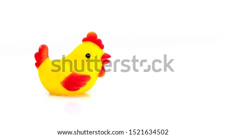 Close up of Little toy chicken sitting on isolated white background