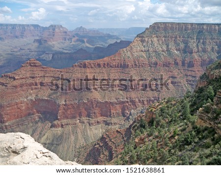 Looking at Grand Canyon South Rim beautiful view from steep cliff on sunny day