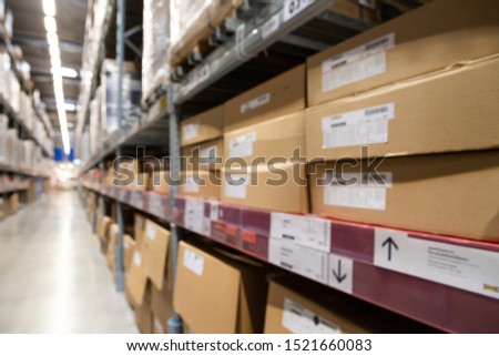 blurred brown goods boxes on full shelves in warehouse storage factory . perspective background with space for business about logistics shipping and wholesale concept . 