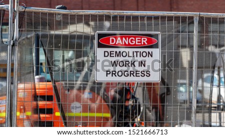 Danger, demolition work in progress sign in a real construction site.  Royalty-Free Stock Photo #1521666713