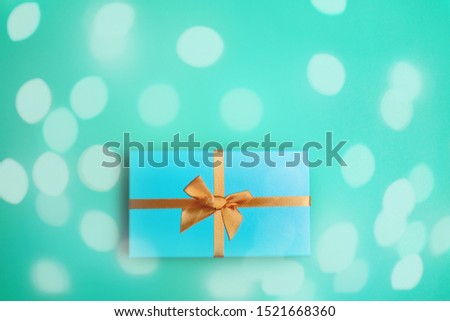 Christmas gift box on mint background flat lay