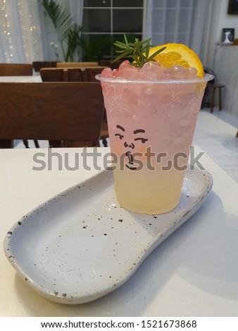 Lemon juice with colourful of jelly and lime in plastic cup on the white table