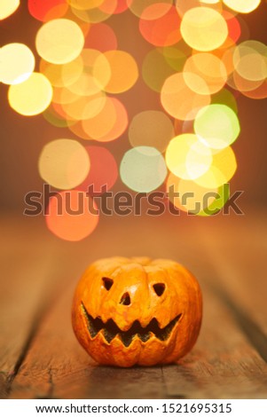 Halloween pumpkin on a bokeh lights background,  copy space for text