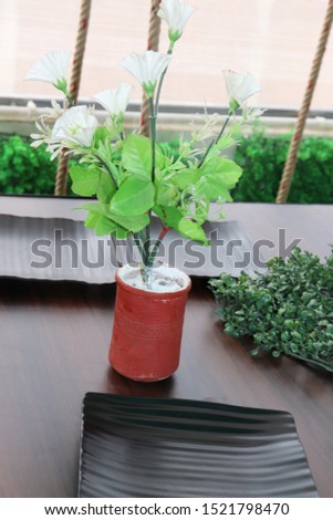 Decorative flower on wooden table in room - Image