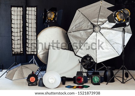 Photo studio equipment flash accessories photographer on black background