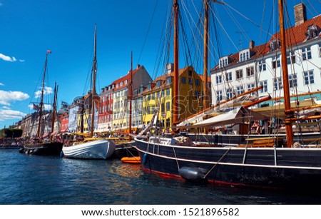 Beautiful cityscape with canal, ships and old buildings. Nyhavn is a 17th-century waterfront, canal and entertainment district in Copenhagen, Denmark.