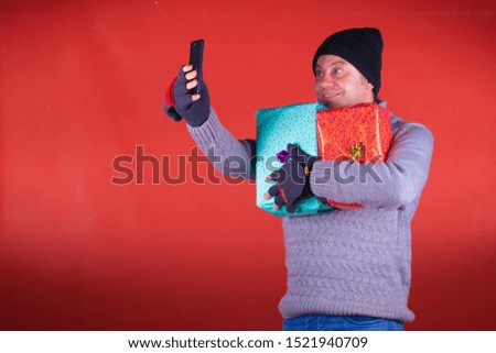 
man with christmas hat taking a selfie with gifts isolated surprised 