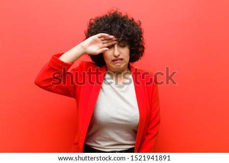 young pretty afro woman looking stressed, tired and frustrated, drying sweat off forehead, feeling hopeless and exhausted