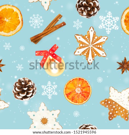 Seamless pattern with Christmas gingerbread cookies in the shape of snowflakes, dried oranges, cinnamon, star anise, christmas ball and pine cone on blue background.