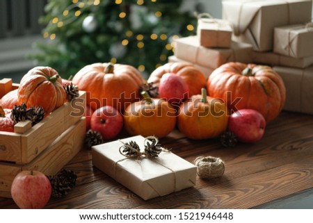 Gift boxes with pumpkins, garlands, apples and cones on a wooden table. Holiday, birthday, new year, christmas. Halloween holiday concept. holiday concept.
