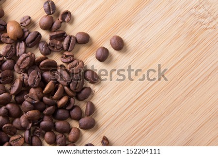 brown coffee beans over wooden background