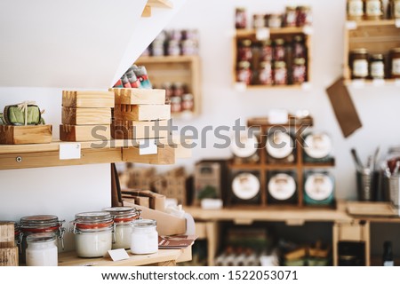 Zero waste shop interior details. Wooden shelves with different food goods and personal hygiene or cosmetics products in plastic free grocery store. Eco-friendly shopping at local small businesses Royalty-Free Stock Photo #1522053071