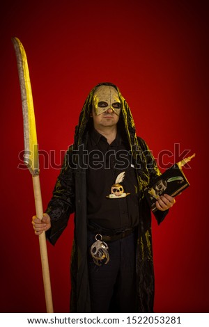 Actor a man in a mask and in costumes of fictional fantasy characters posing on a red background