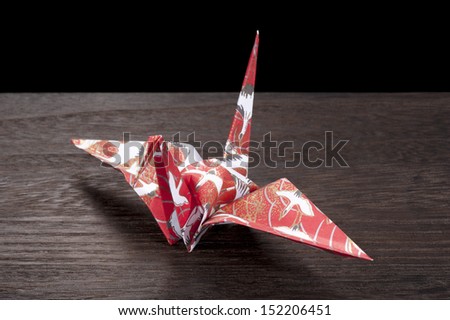 origami crane on wooden table