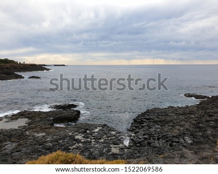 Sea water, cloudy sky and rocks view, nature photography 