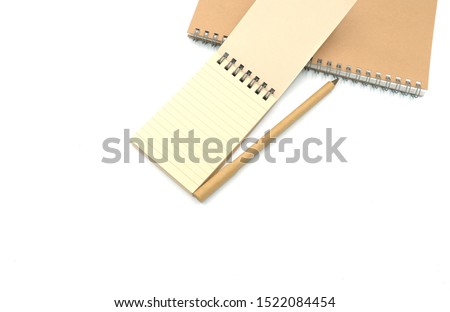 stationary brown note book and pen . Recycle paper for save natural on earth. Isolated on white background