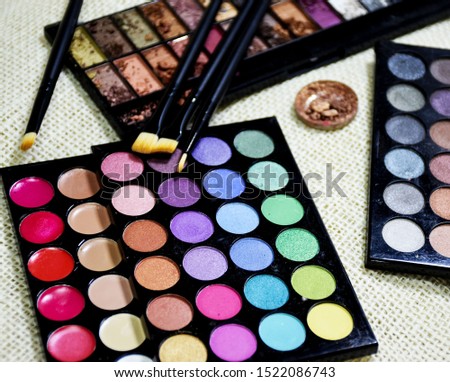 Eye shadow colorful shattered into powder. Make up brush.