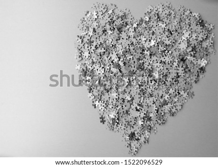 heart, symbol of love, made with small puzzle pieces and text space