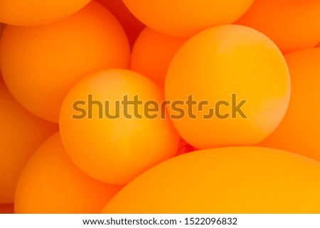 Festive composition with bunch of matte orange balloons. Macro shot, close up, background with a lot of copy space for text.