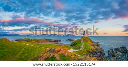 Sunset panorama of Lighthouse on Llanddwyn Island at the coast of Anglesey in North Wales,UK Royalty-Free Stock Photo #1522115174