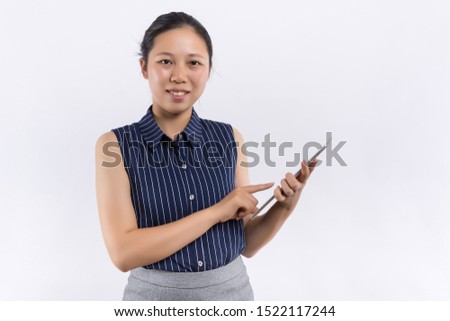 A beautiful woman portrait: Business asia woman is using new technology and finding some information for her work. Charming businesswoman feels happy and enjoy her work. Gorgeous woman stand at office