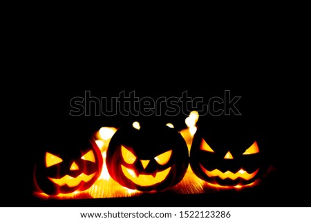 pumpkin background Halloween. happy Spooky scary pumpkin head or jack lantern smiley funny horror magic face soft-focus glow in the dark background with bokeh. October Halloween design with copy space
