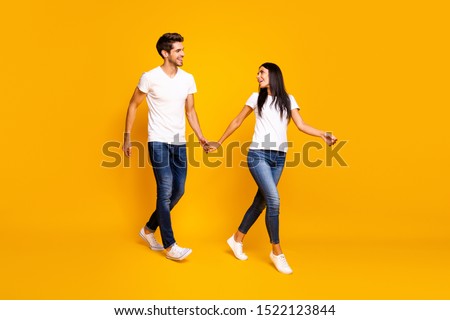 Come with me honey! Full body photo of two people walking down street for shopping wear casual clothes isolated yellow color background
