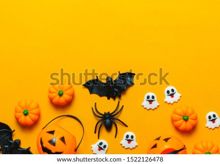 Halloween holiday concept, Pumpkin, bats, spider and tiny ghost in orange background with copy space for text, Top flat view wallpaper