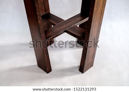 Solid wooden coffee table with acrylic table top on white background. Close-up