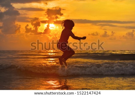 A kid jumping in the water.