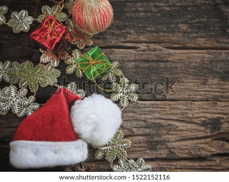 Christmas decorations and hat on wood background