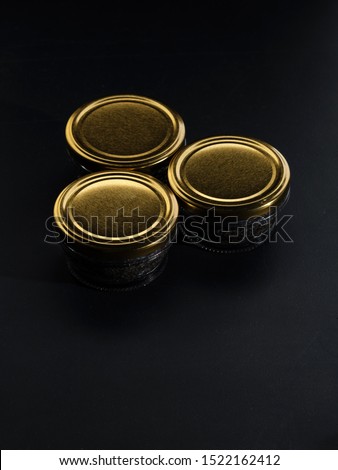 Glass jars with black sturgeon caviar. Black sturgeon caviar. Luxurious black caviar. 