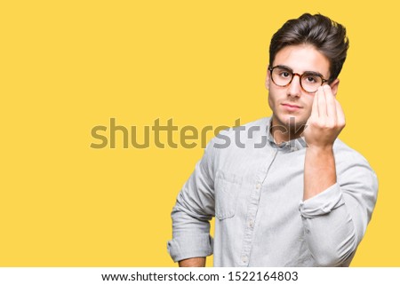 Young handsome man wearing glasses over isolated background Doing Italian gesture with hand and fingers confident expression