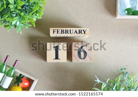 Background Design with number cube strawberry pine apple and wine in natural concept, February 16.